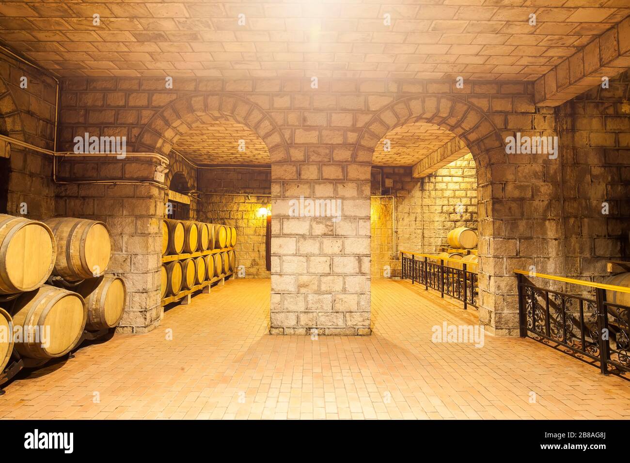 Wine barrels stacked in the cellar of the winery Stock Photo - Alamy