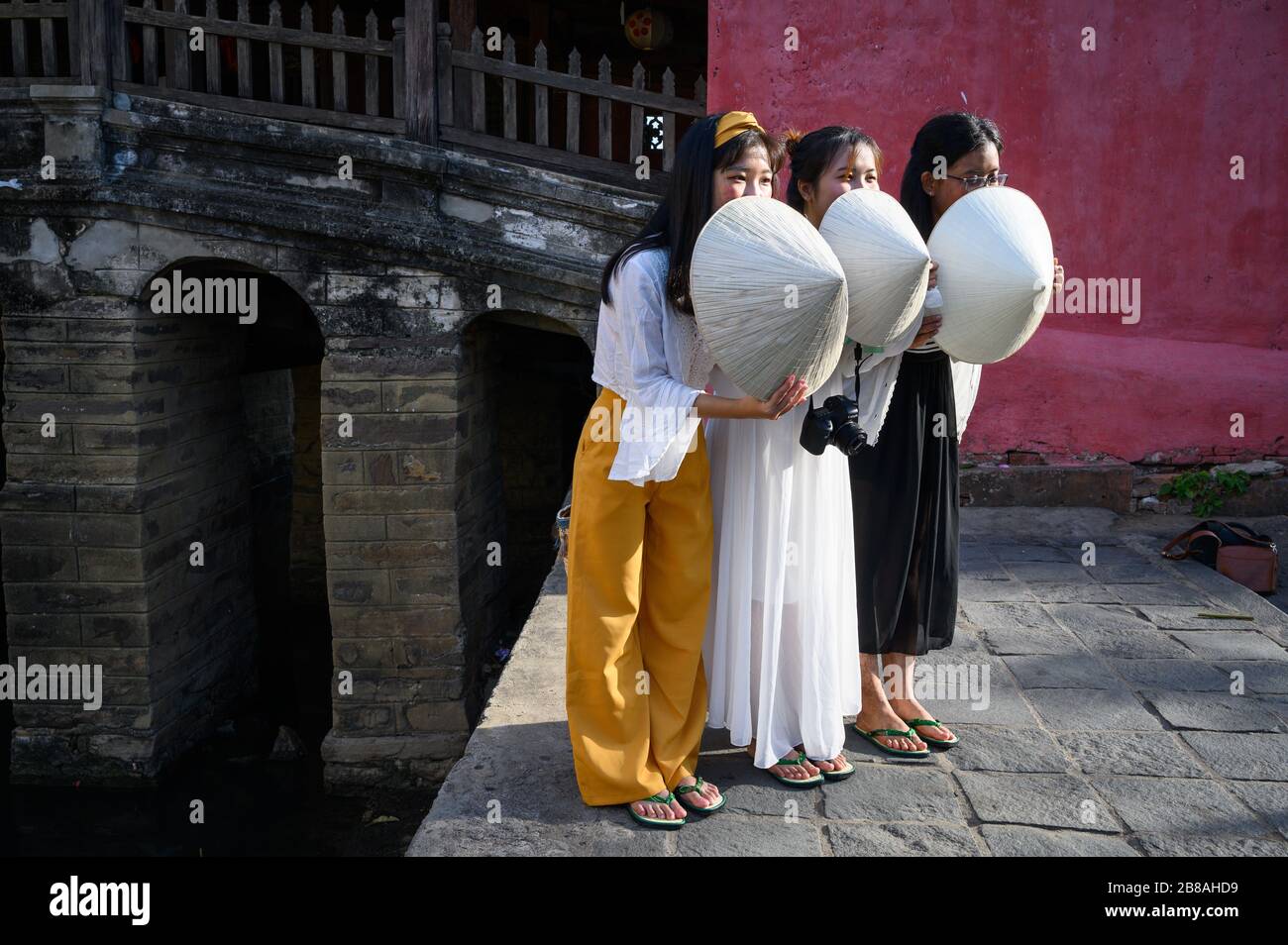Young Vietnamese tourists posing with conical hats, Hoi An, Vietnam Stock Photo