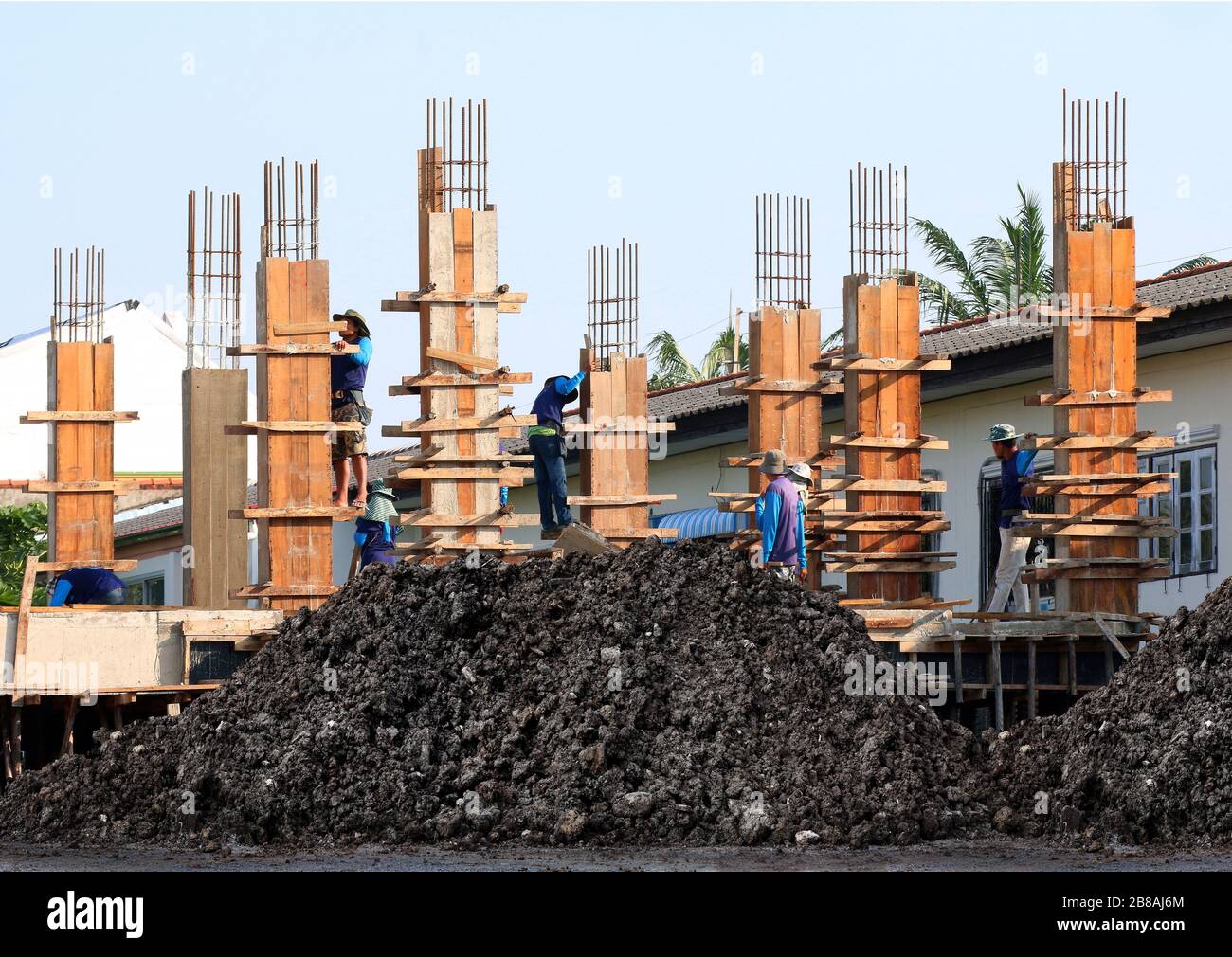 Soil mound, Clay wet black and Construction Site, Construction workers, People labor are working on construction building, Group of People are Profess Stock Photo