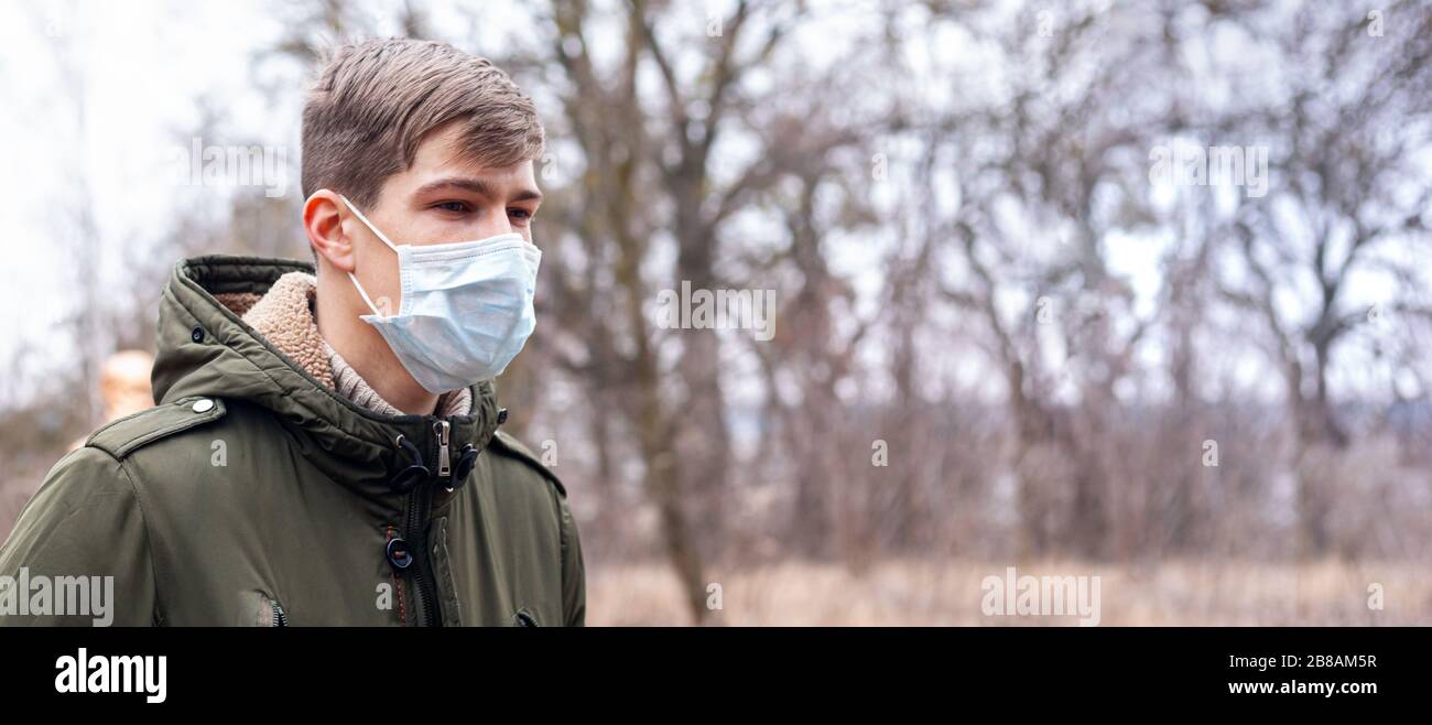 Man in a medical mask on the street. coronavirus is an endemic virus in China. disease protection for children. health safety concept covid-19. Stock Photo