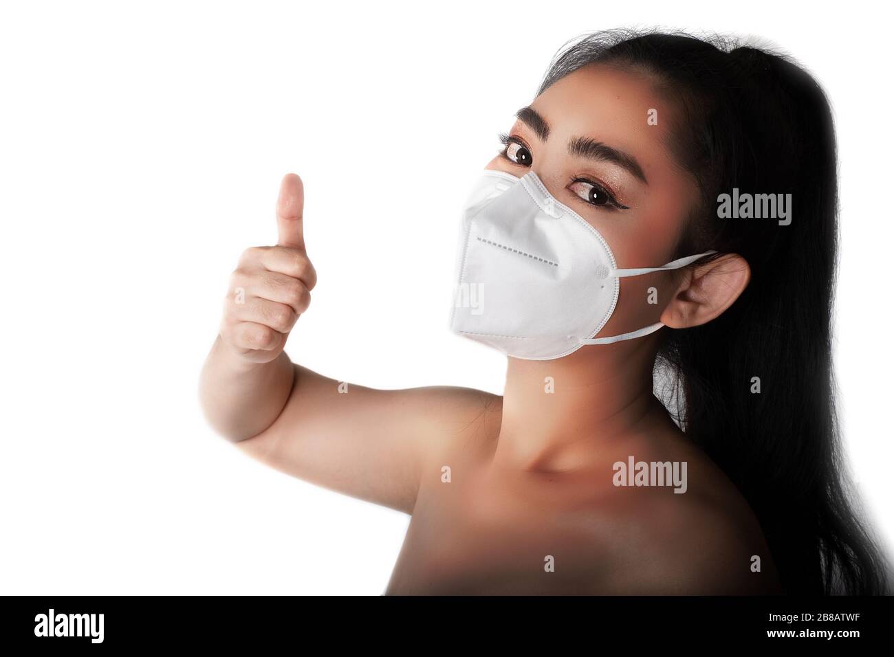 Close up of a woman putting on a respirator N95 mask to protect from ...