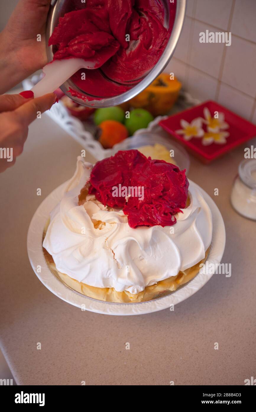 Making Pavlova cake with fruit cream Stock Photo