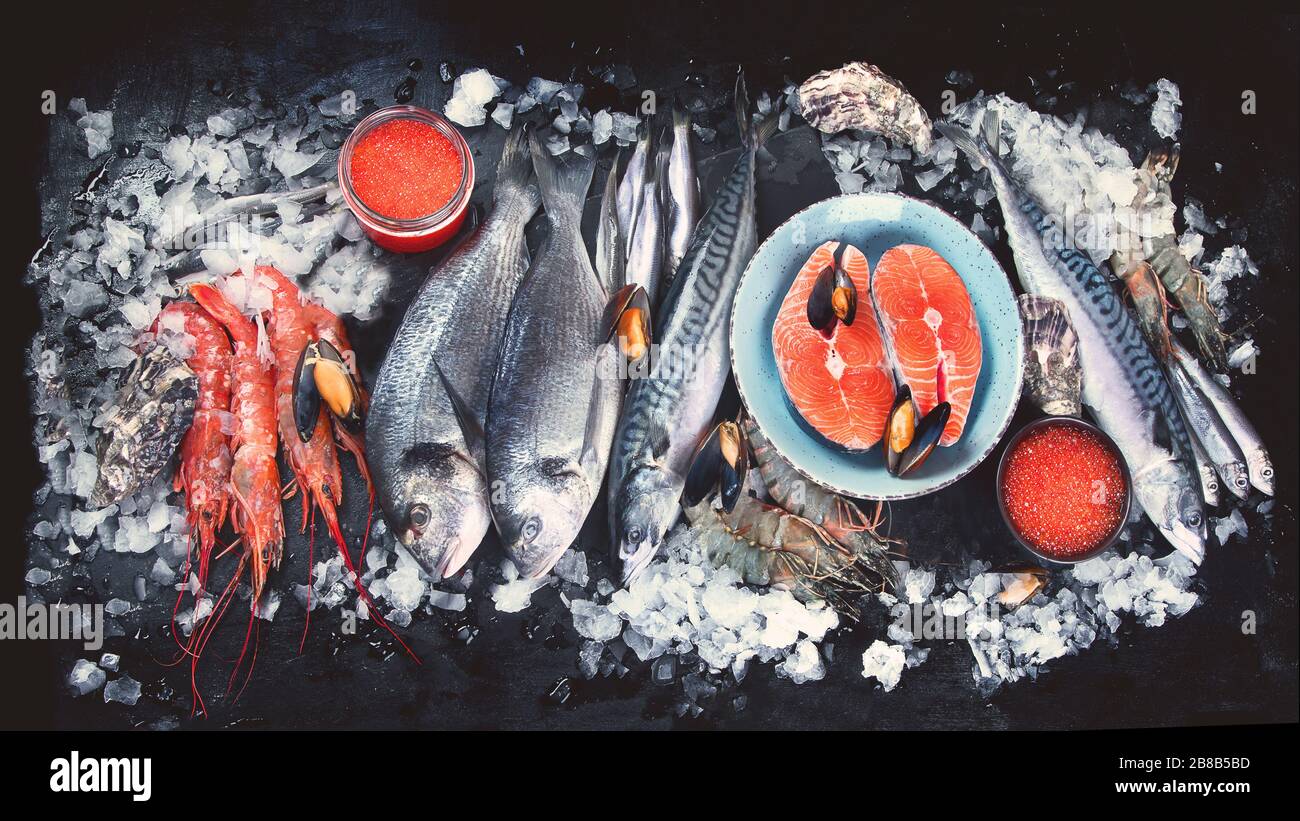 Fresh fish and seafood on black background. Top view, flat lay Stock ...