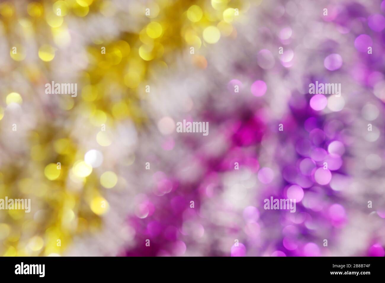 blurred picture yellow gold and purple bokeh colorful glittering for merry christmas and happy new year festival background design Stock Photo