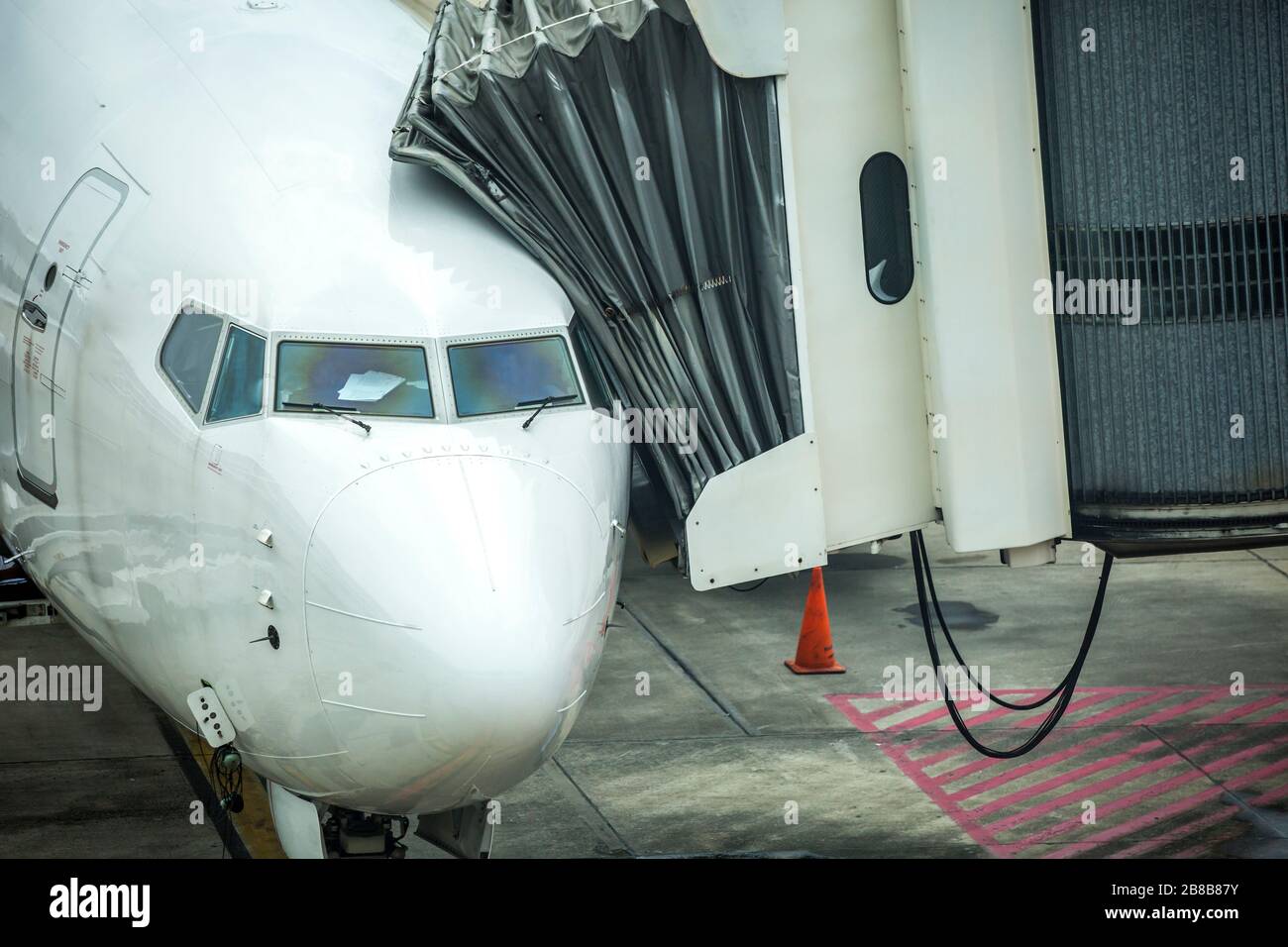 Close up on a white jetliner. Passenger plane at the airport. Suspended flights due to coronavirus outbreak. Stock Photo