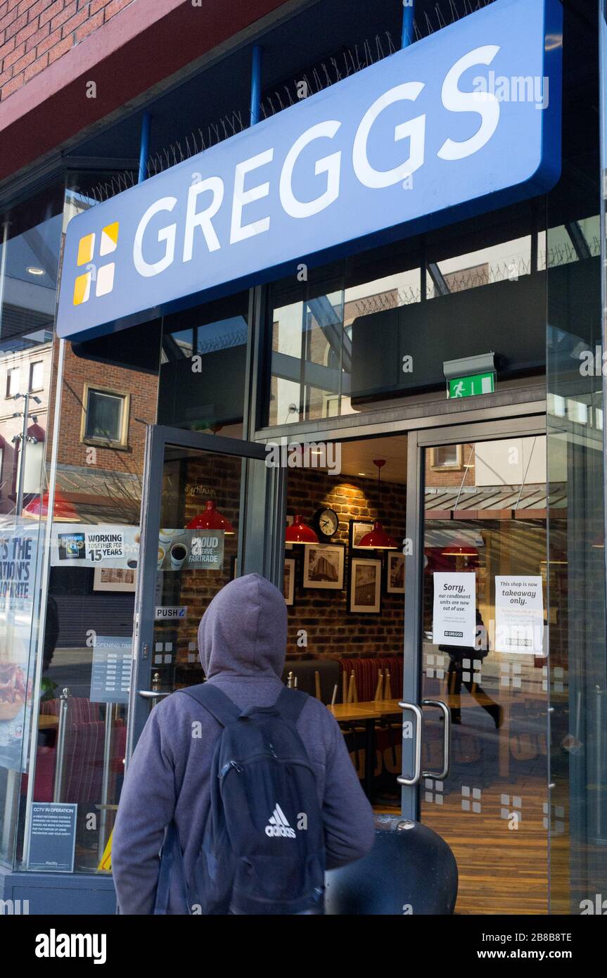 21st March 2020 Harrow London. A man walkling into Greggs in Harrow on the Hill town Center Today 21/03/2020 , Greggs is offering only takeaway service due to Boris Johnson MP ordereding Britain Pubs, Bars and Restaurants to close, part of tougher measures to protect citizens from coronavirus. Stock Photo