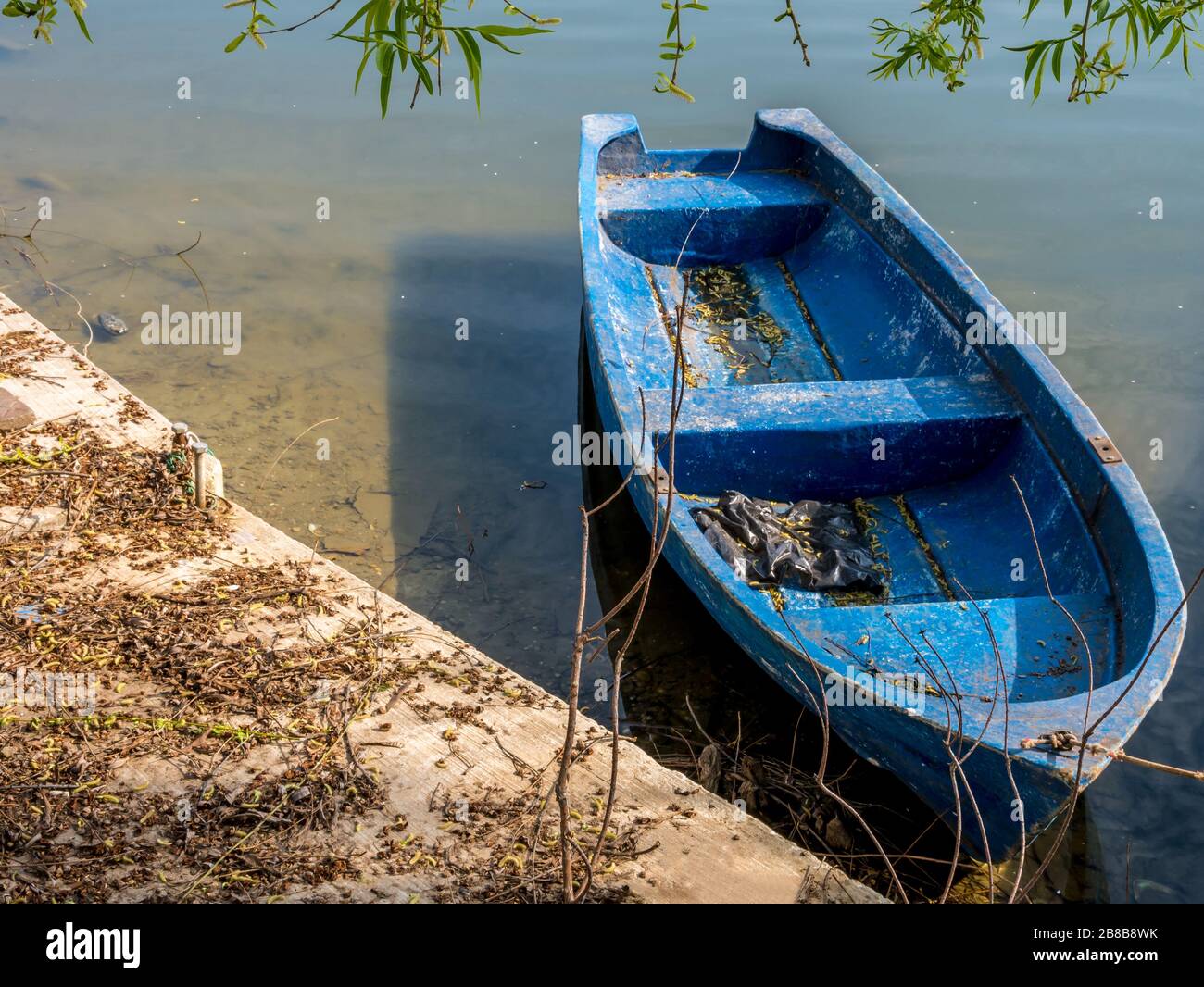 Old blue fishing boat. Worn out wooden boat on a lake Stock Photo - Alamy