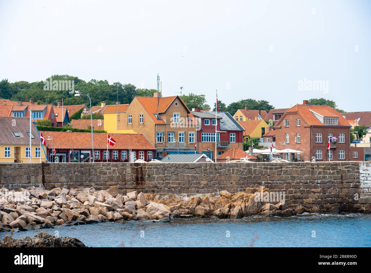 Svaneke, Bornholm / Denmark - July 29 2019: View of the small town of Svenek in Bornholm from accross the bay Stock Photo