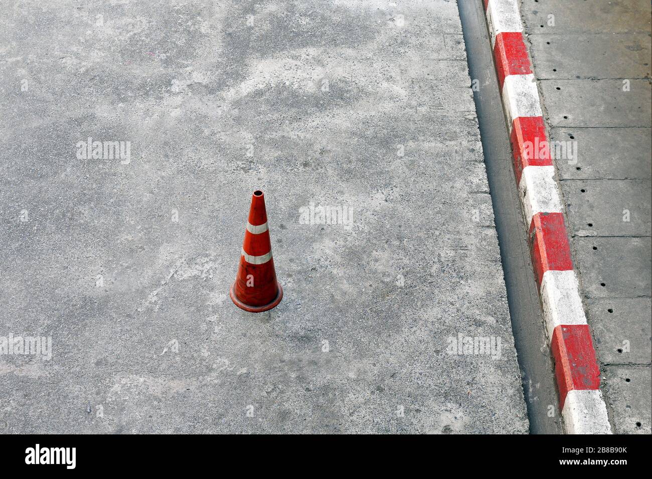 Traffic cones, Cement ground floor and plastic traffic cones red and white stripes is Safety equipment on the road Stock Photo