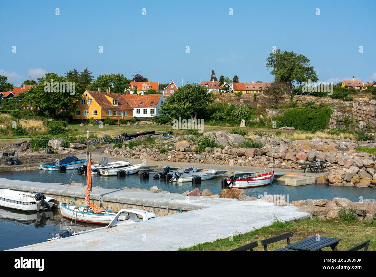 Svaneke, Bornholm / Denmark - July 29 2019: View over the Village Svanake in Bornholm with a small harbor in front Stock Photo