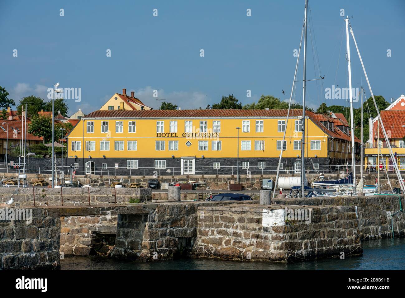 Svaneke, Bornholm / Denmark - July 29 2019: Old hotel in Svanake, Bornholm with the harbor infront Stock Photo