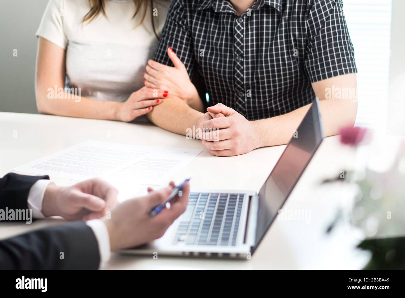 Couple having meeting with banker in bank or salesman in office. Financial consulting and guidance. People asking professional help. Stock Photo