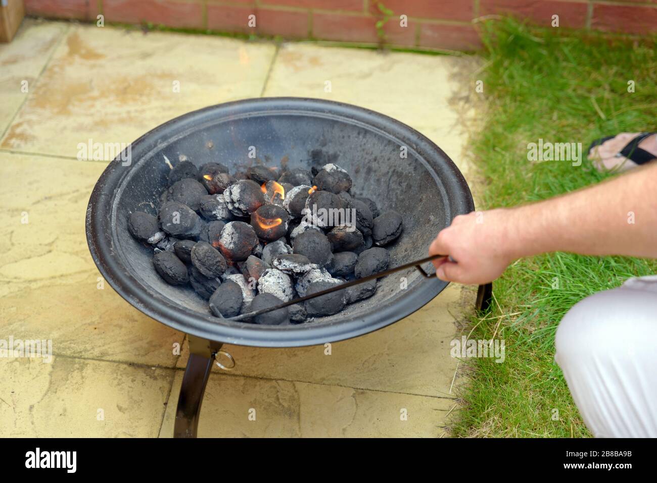 bbq grill charcoal starting fire for party in backyard in england uk