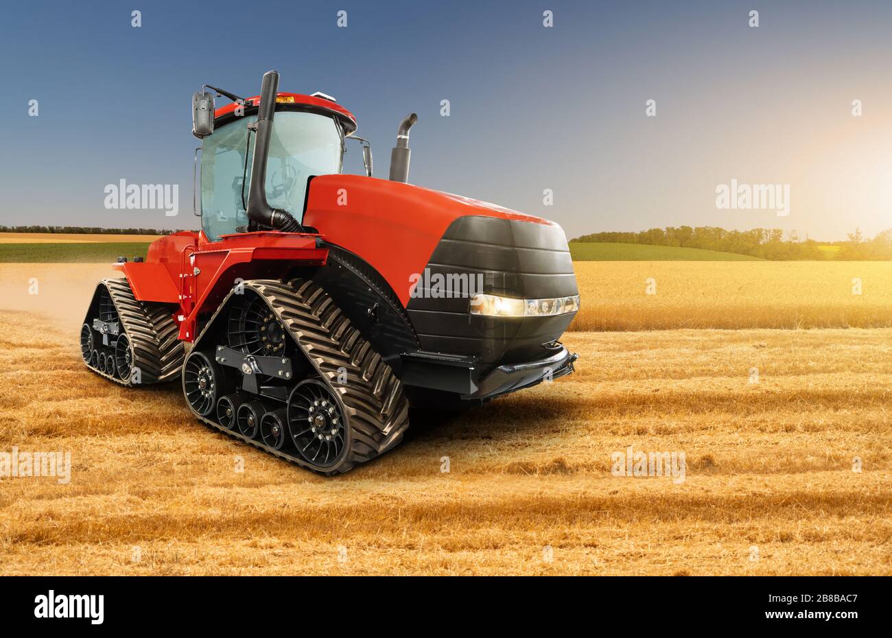 Red rubber tracked agricultural tractor Stock Photo