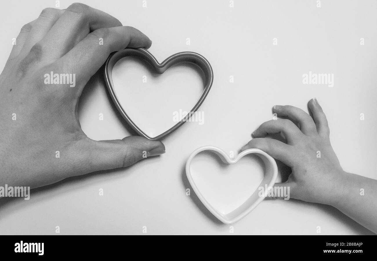 Two hands holding hearts Stock Photo