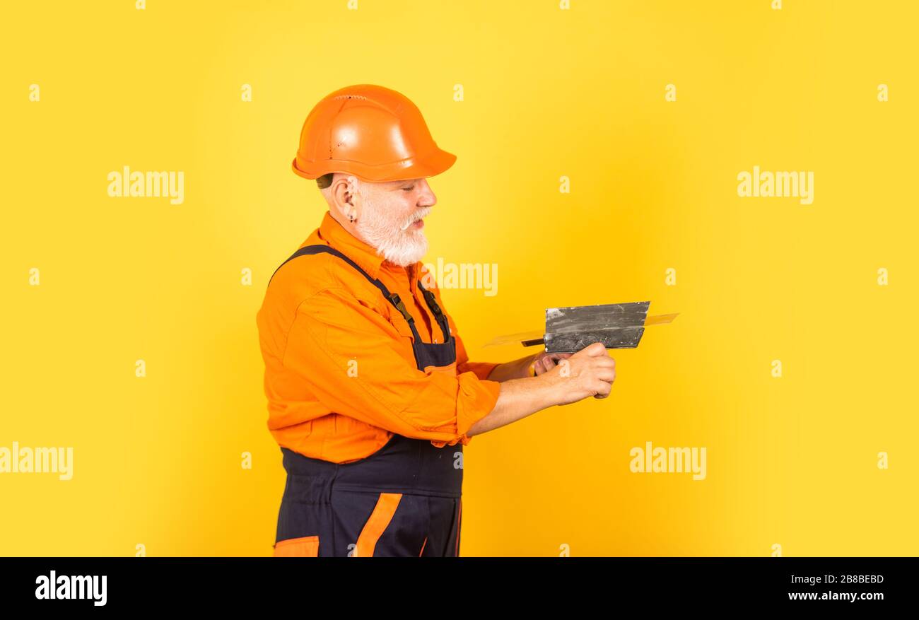 Plaster Manb He needs little break. Plasterer in working uniform plastering. man ...