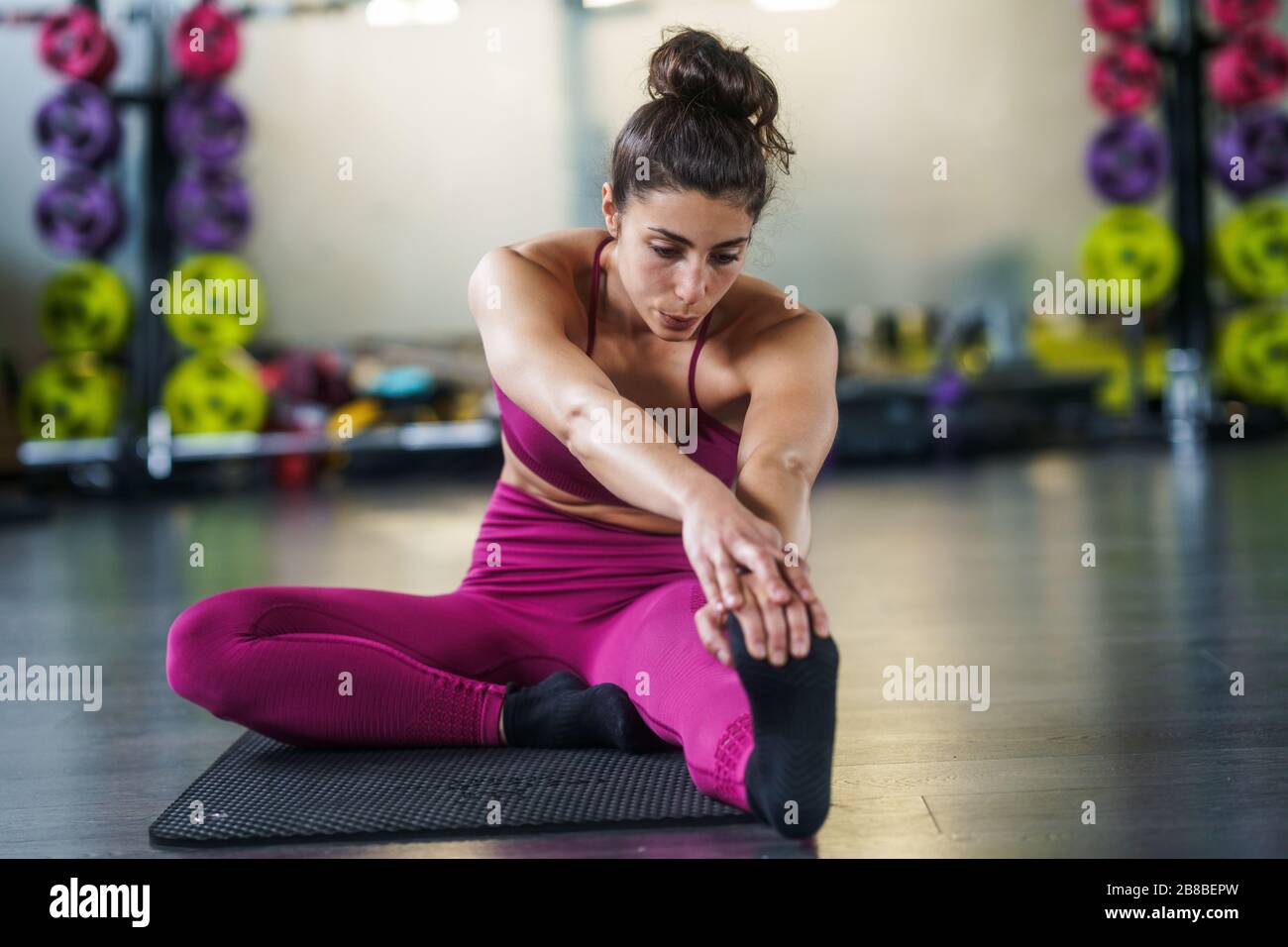 Young woman Doing Stretching Exercises on a yoga mat Stock Photo - Alamy