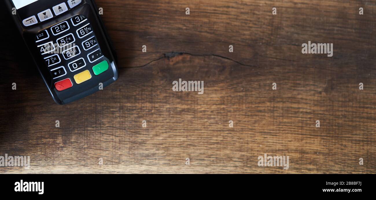 Bank pos terminal on a wooden background.  Stock Photo