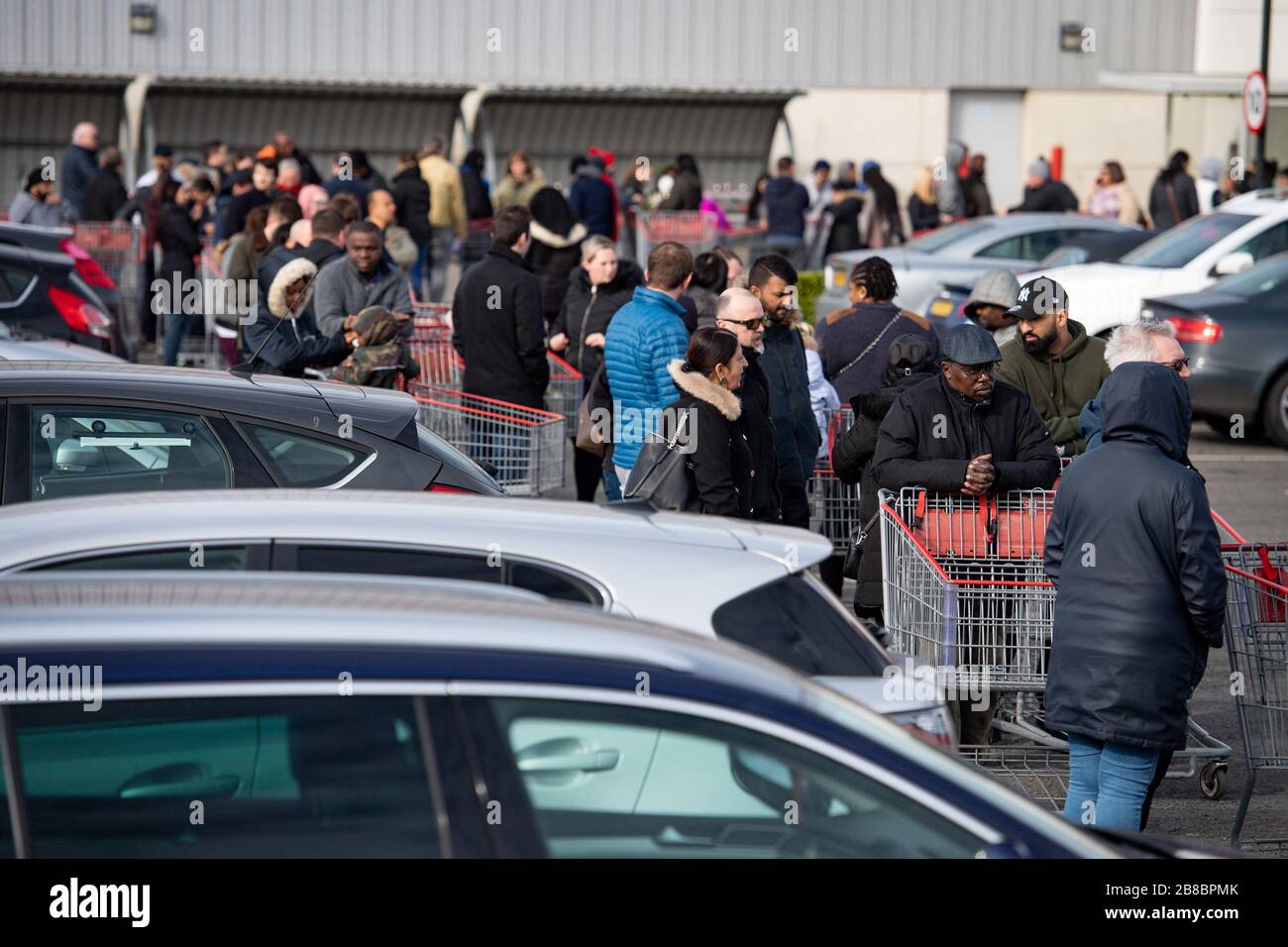 Hundreds of people queue to enter a Costco Wholesalers in Coventry on Saturday as the Prime Minister Boris Johnson told restaurants, cafes, pubs, bars, gyms and leisure centres to close whilst pleading the public to stay at home. Picture date Saturday 21st March 2020. See PA story HEALTH Coronavirus. Photo credit should read: Jacob King/PA Wire Stock Photo