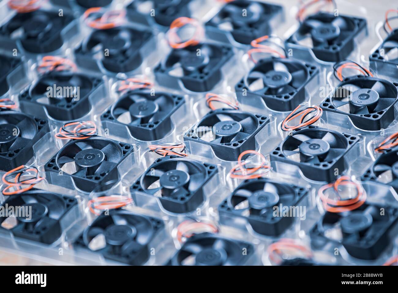 Closeup small plastic computer coolers with wires lie in transparent
