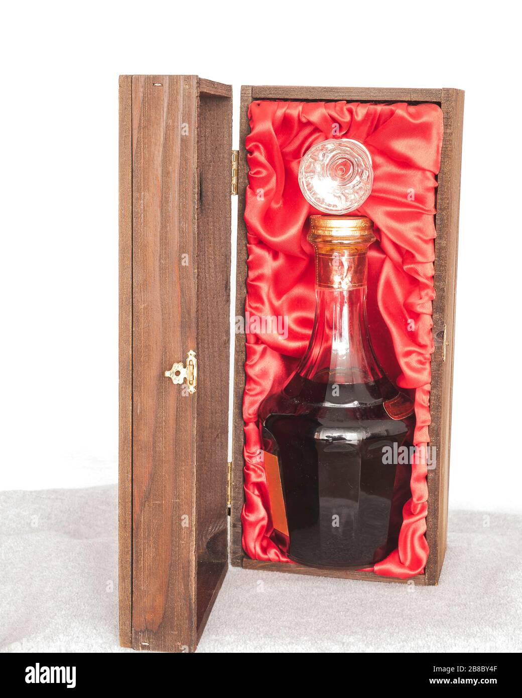 dark liquor in fancy crystal bottle packaged in elegant oak wood box