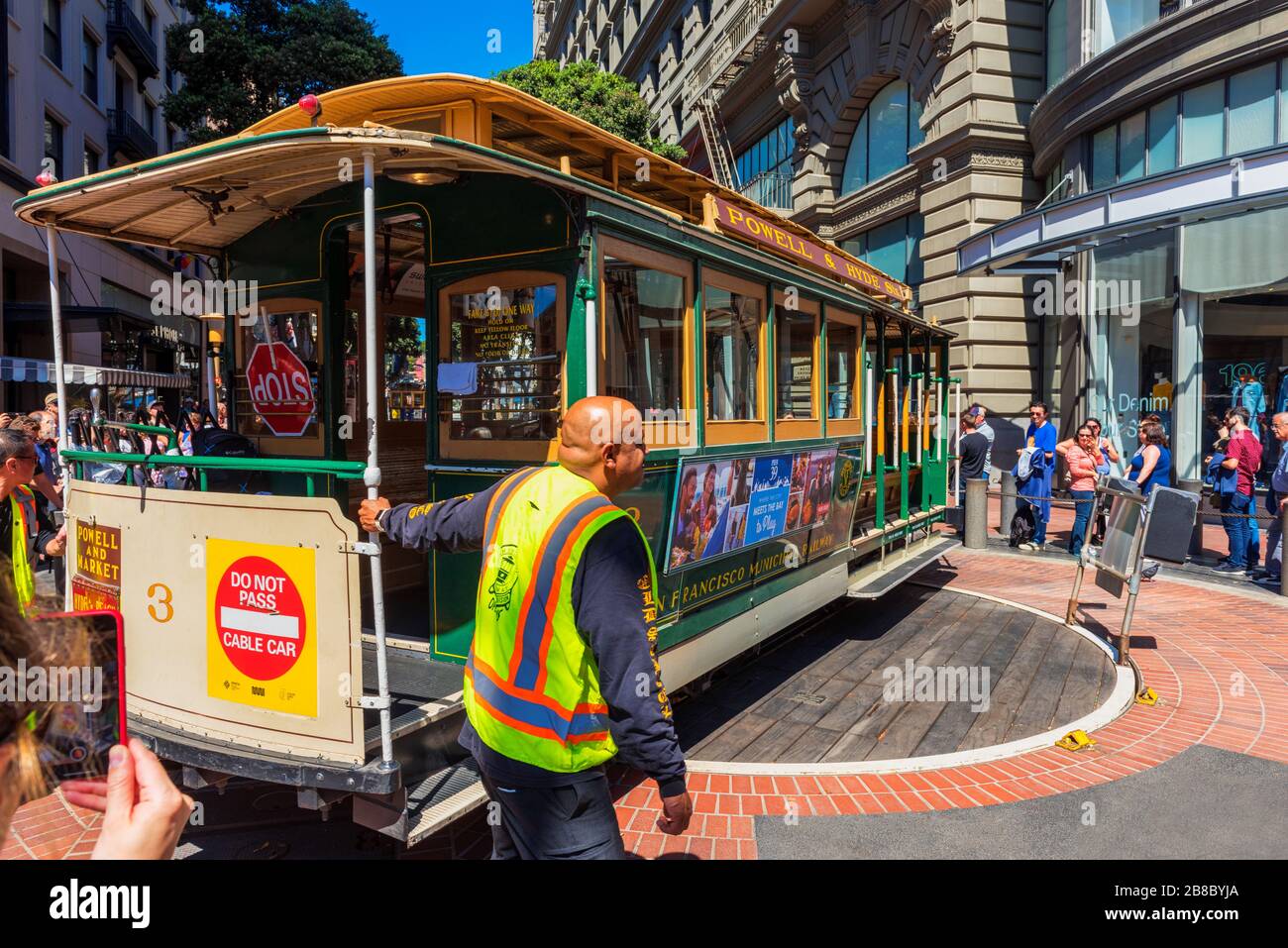 Operator turning a cable car around in the reverse direction at the Powell and Market Street Turntable in San Francisco USA Stock Photo