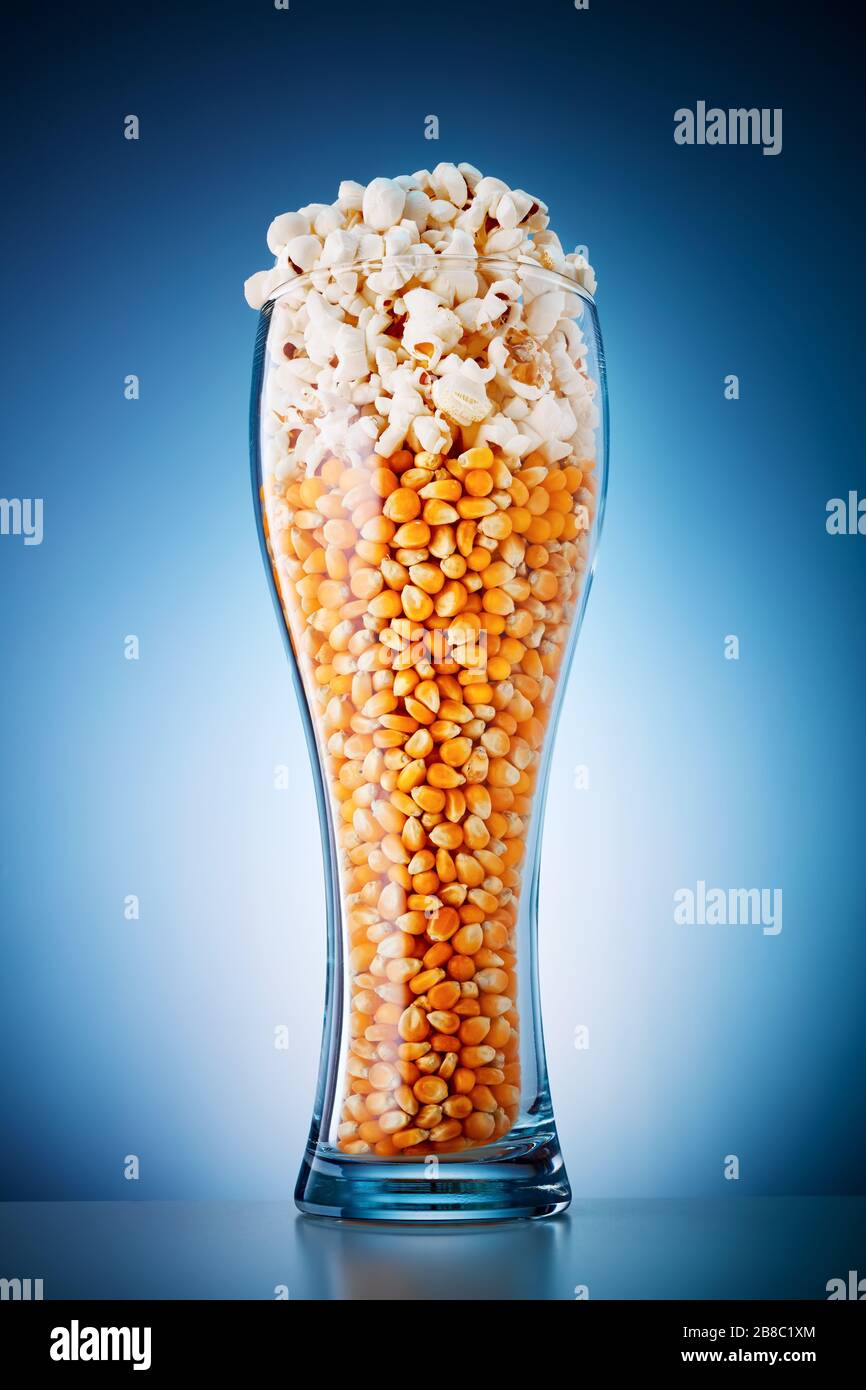 Beer glass filled with popcorn and corn kernels. Beer and popcorn snack