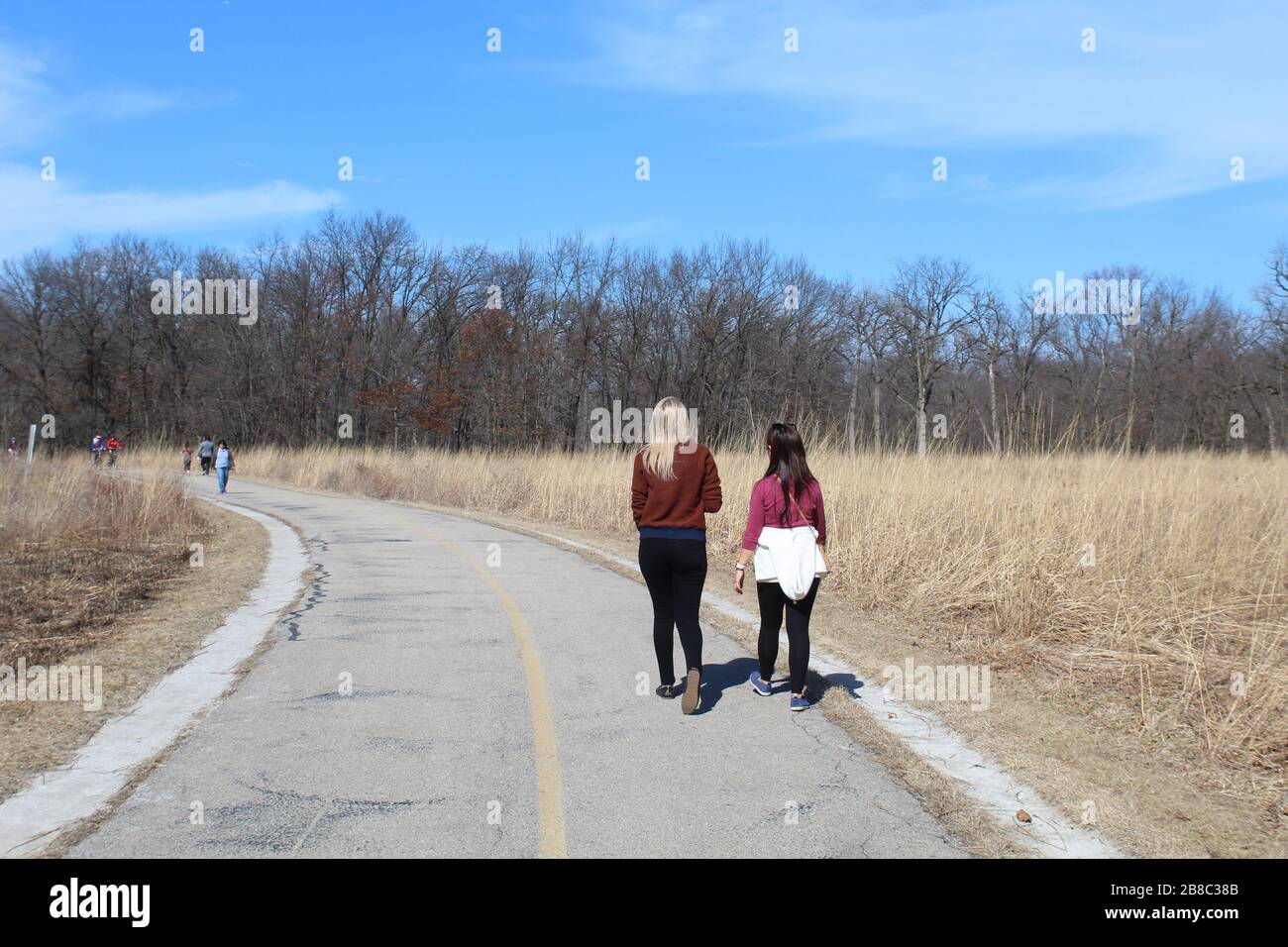 Two young women walking on a busy North Branch Trail at Miami Woods in Morton Grove, Illinois Stock Photo