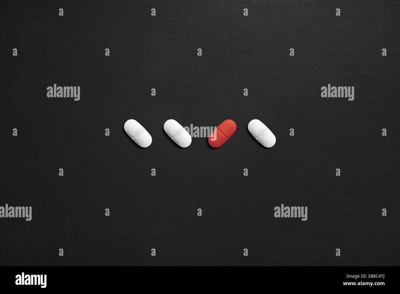 One different pill. Unique or individual. Mental health care, loneliness or malpractice. Wrong or dangerous drug. Placebo effect or medicine test. Stock Photo