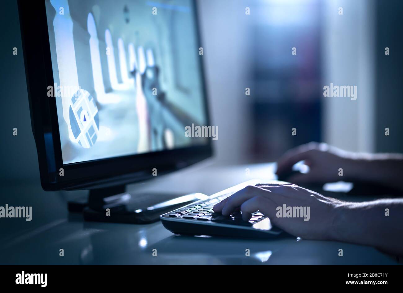Man playing fps video game with desktop computer. E sports professional in competitive event. Team strategy and battle videogame streaming. Stock Photo