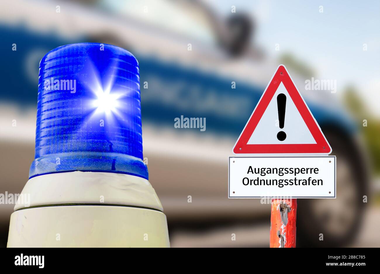 Flashing blue warning sign Corona parties regulatory office in german Stock Photo