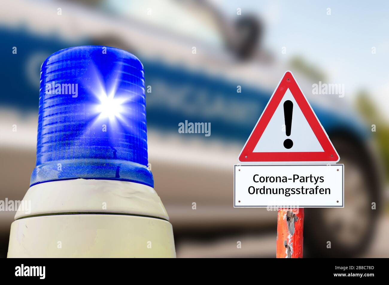 Flashing blue warning sign Corona parties regulatory office in german background Stock Photo