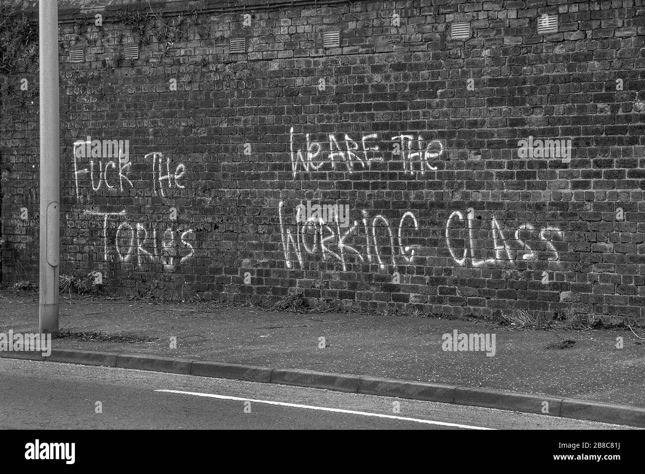 Rutherglen, Scotland, UK. 21st March 2020: Black and White images of an anti- Conservative graffiti on Shawfield stadium brick wall. Stock Photo
