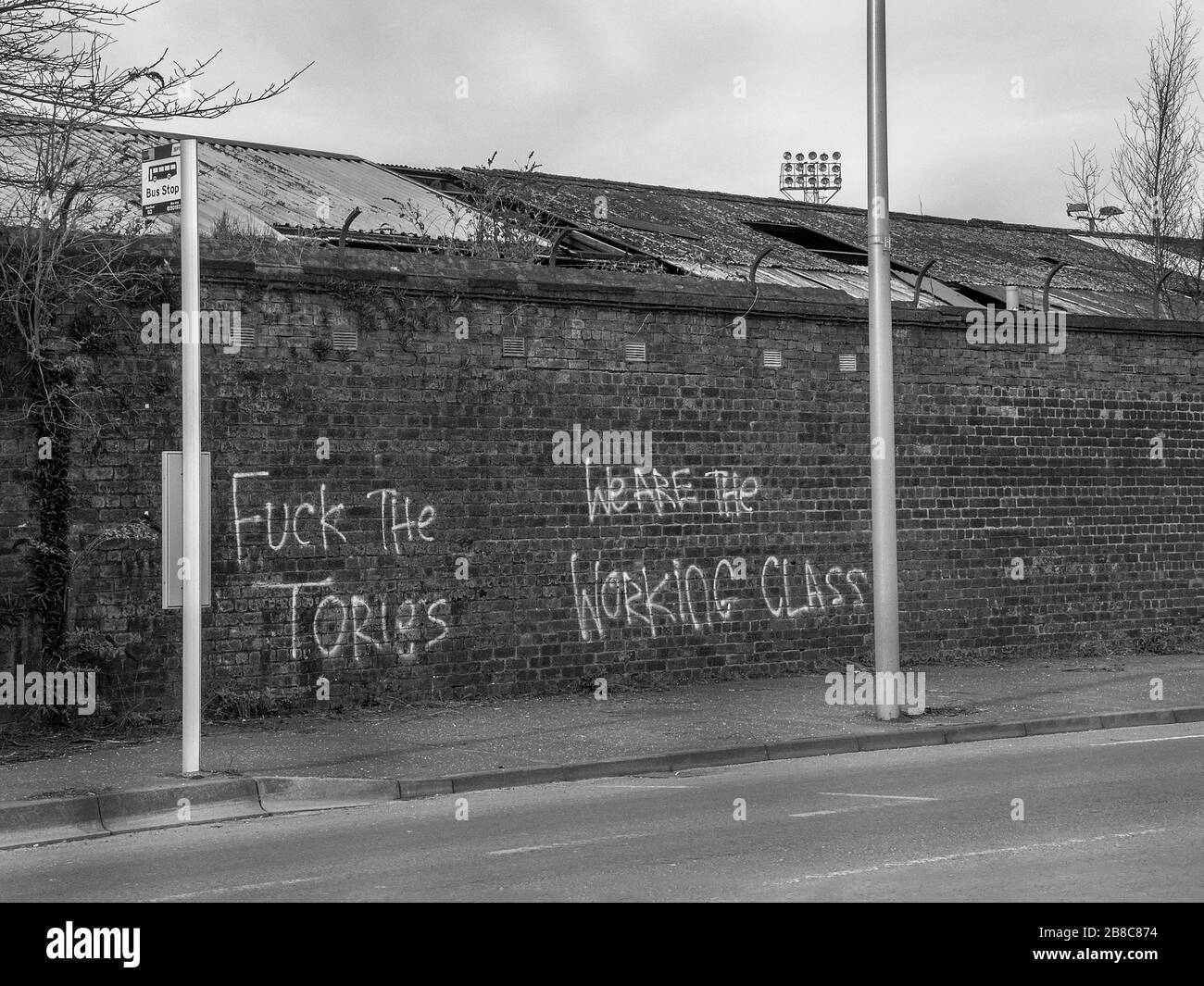 Rutherglen, Scotland, UK. 21st March 2020: Black and White images of an anti- Conservative graffiti on Shawfield stadium brick wall. Stock Photo