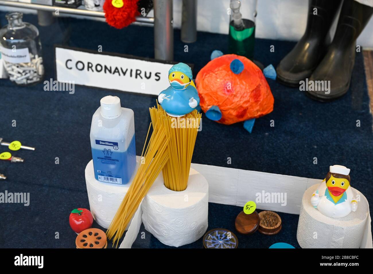 GERMANY, Hamburg, Corona Virus, COVID-19 , corona theme shopping window of a closed shop on reeperbahn, St. Pauli district, rare items during Hamster purchase: antiseptics, noodle, toilet paper Stock Photo