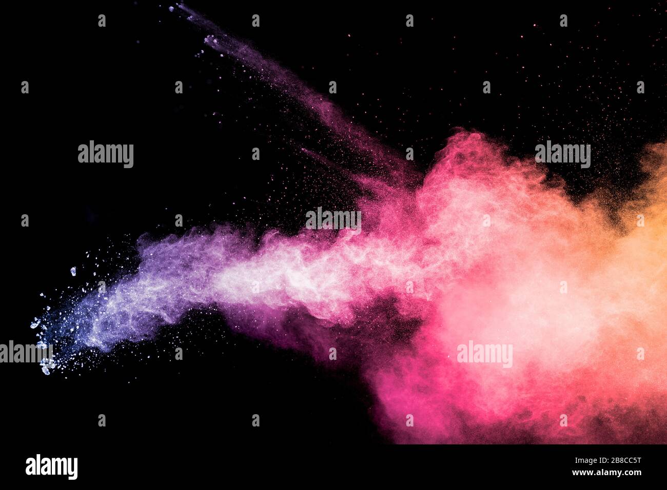 Colorful background of pastel powder explosion.Rainbow color dust splash on black background. Stock Photo