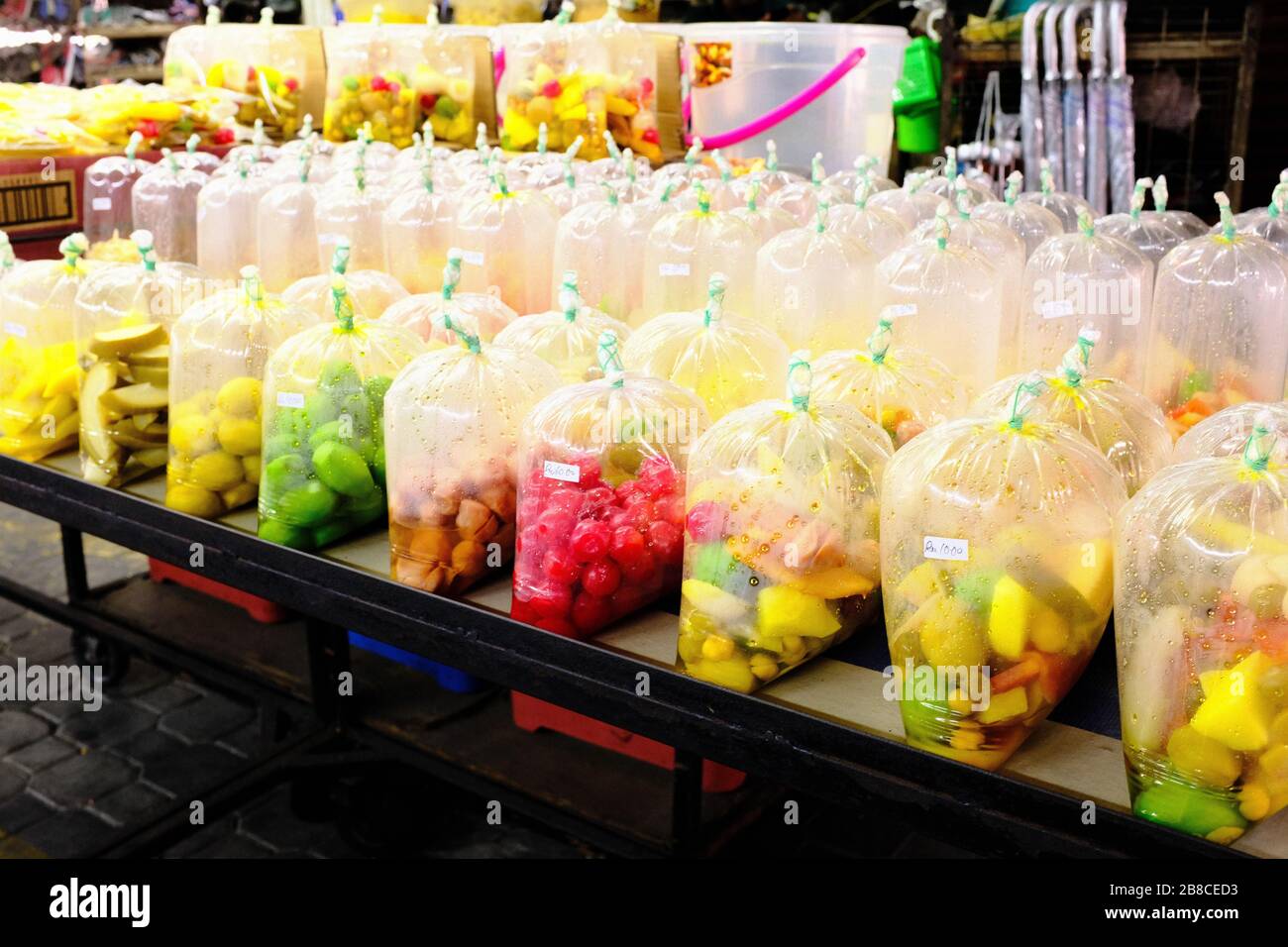 Fruit wrapped in plastic for sale on market, Penang, Malaysia Stock