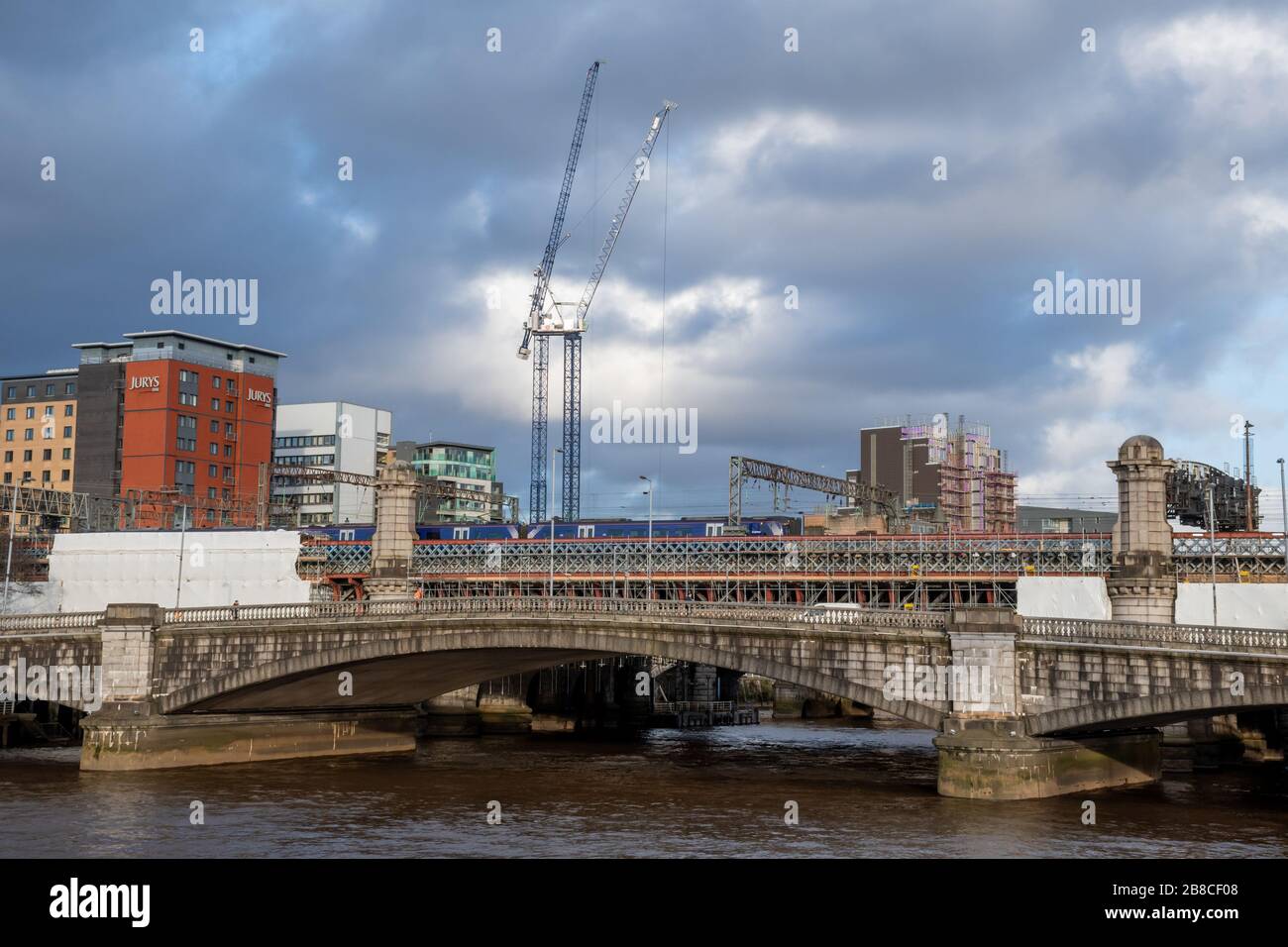 King George V Bridge and Central Station Railway Bridge with two tower cranes in the background shining in the sun Stock Photo