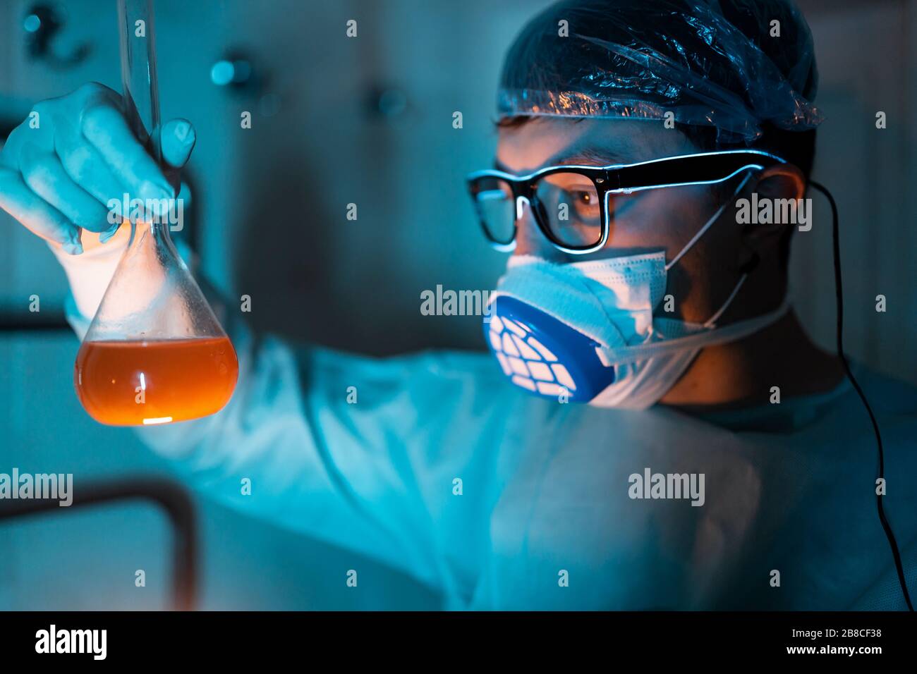 Young male researcher carrying out scientific experiment. Stock Photo