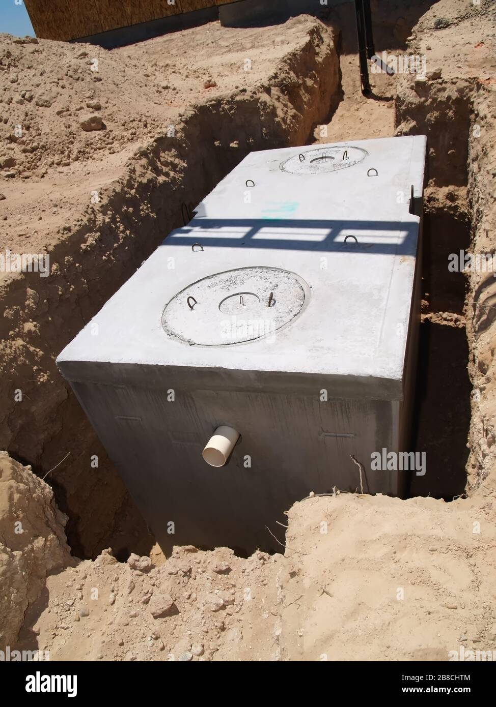 A brand new septic tank ready to be connected to a newly constructed home and then covered with soil to hide it from view. Located in Arizona. Stock Photo
