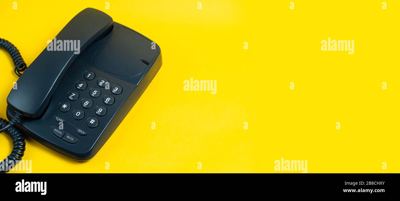 Landline telephone device on yellow background Stock Photo Alamy