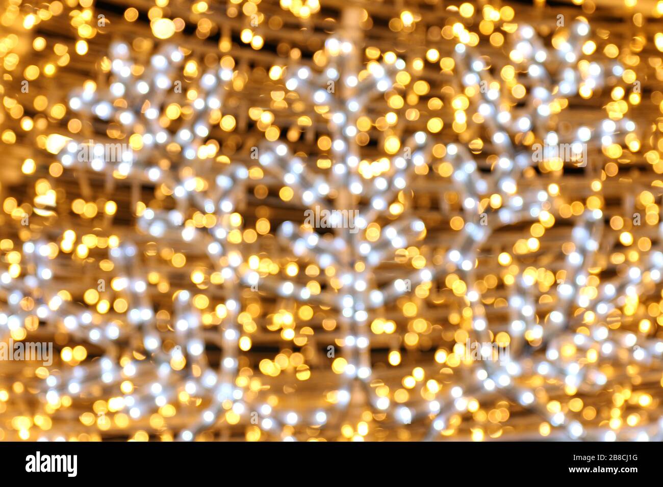 Bokeh background and snow shape gold yellow colorful merry christmas, Happy new year bokeh lighting shine on night background, Bokeh glitter light, Go Stock Photo