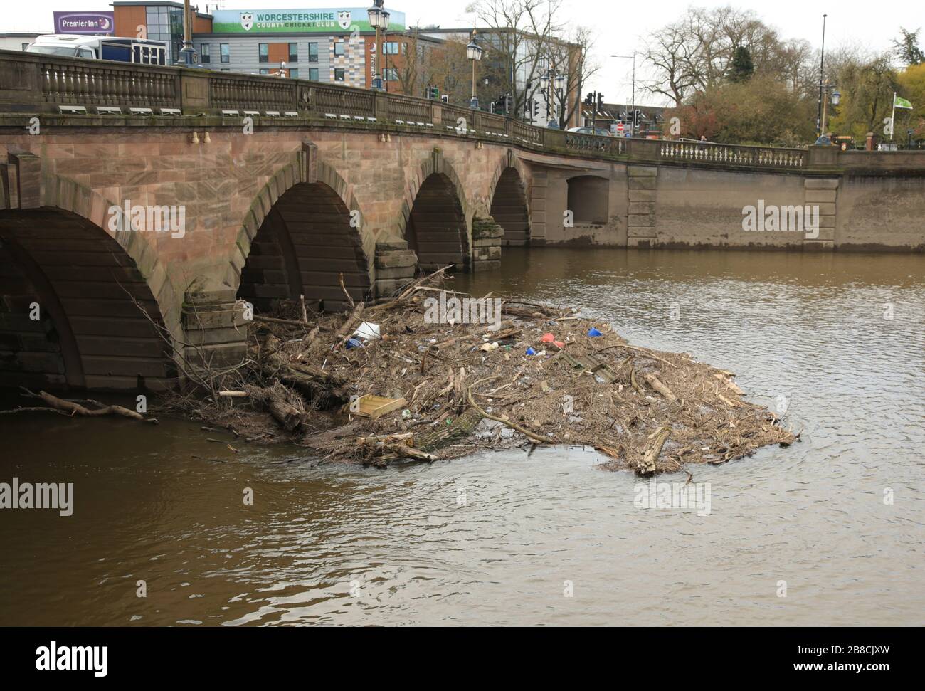 Flood debris trapped under Worcester bridge on the river Severn
