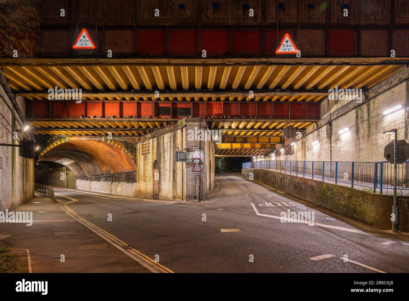 Vyne Road / Chapel Hill railway bridge E1/135A on railway line BML1 in Basingstoke at night time. RBE steel girder and brick arch construction. Stock Photo