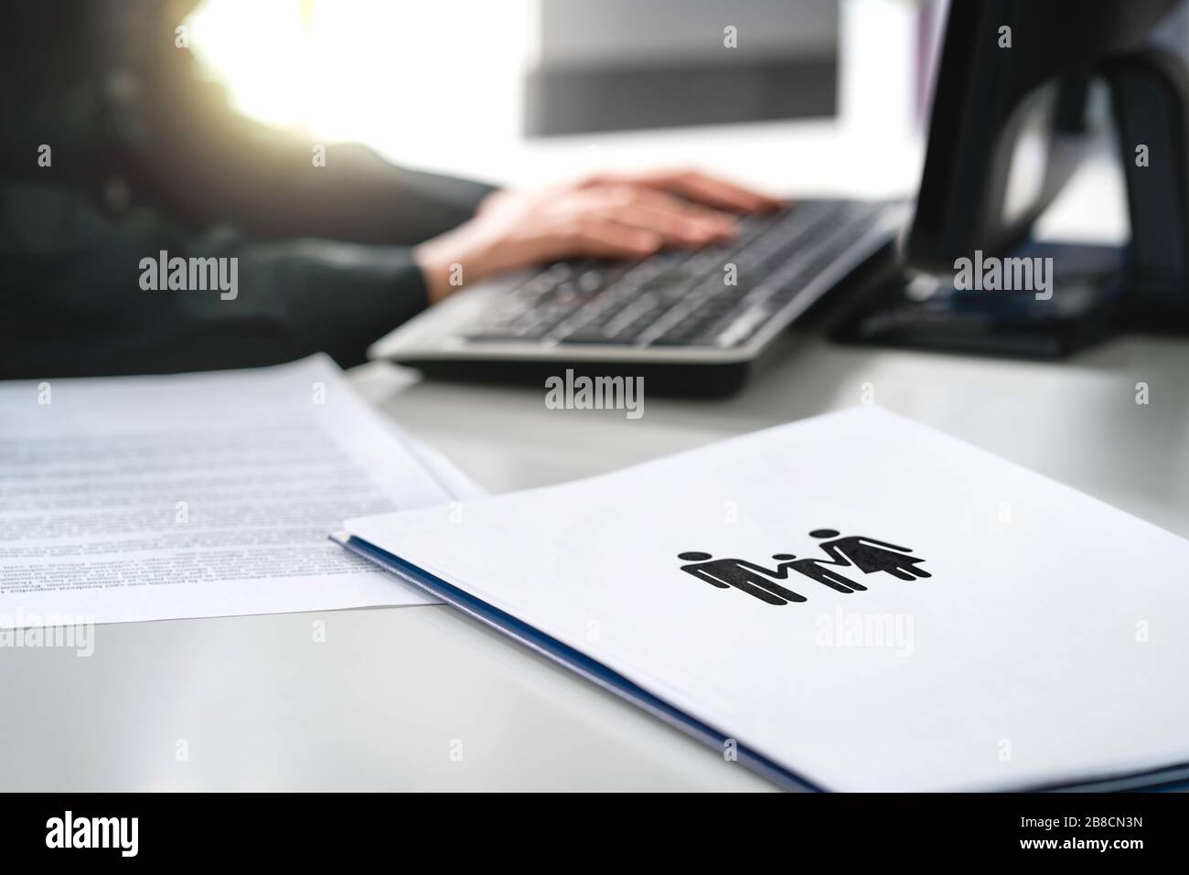 Family future, health care or finance planning concept. Woman writing insurance or mortgage application with computer. Lawyer working on legal case. Stock Photo