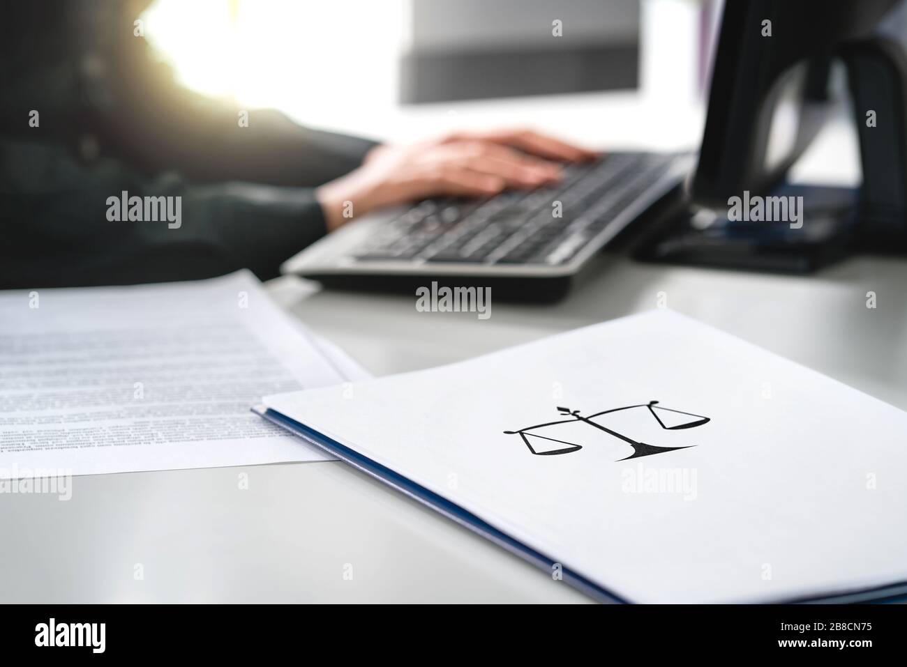 Attorney with computer. Lawyer working in law firm and company. Solicitor or jurist doing paperwork. Professional business woman writing her will. Stock Photo