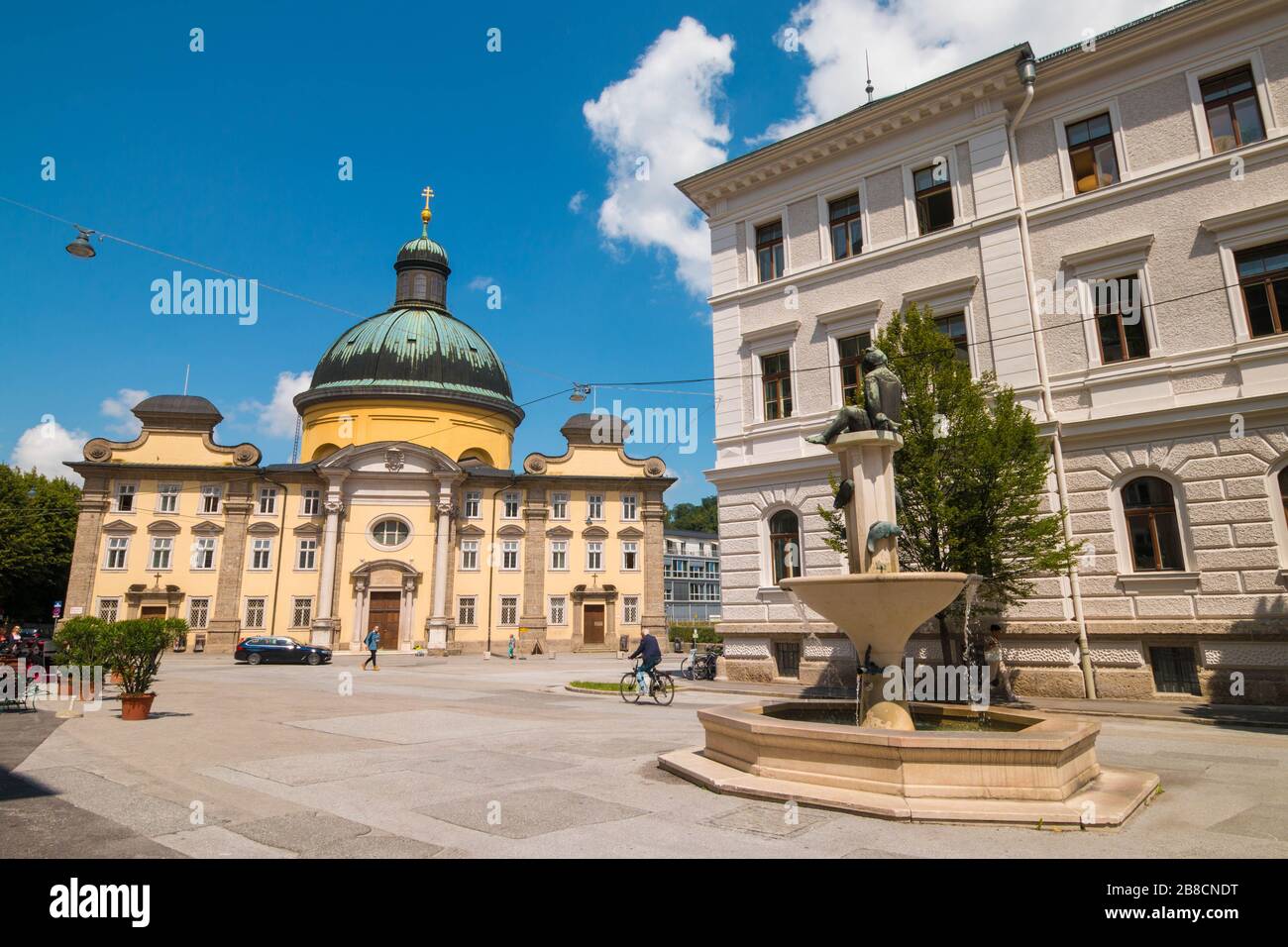 Salzburg, Austria - July 15, 2019: Kajetanerplatz (Cajetan square) with  Putto mit Fischen (Putto with fish) fountain by Gertrude Hillinger-Diener and Stock Photo