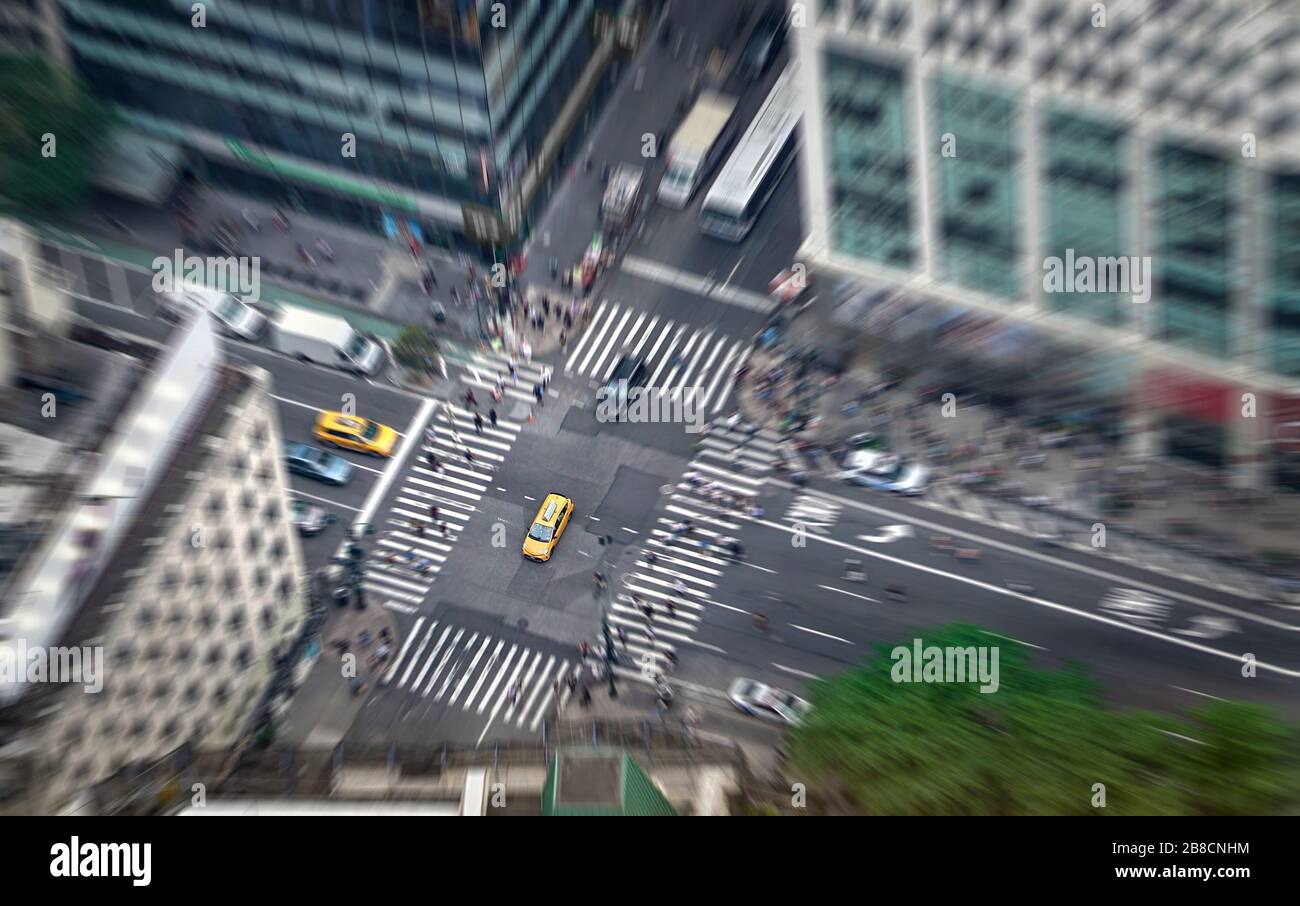 New York city street full of taxis, cars and pedestrians. Yellow cab in focus. Busy NYC Downtown. Crowd of people crossing crosswalks. Traffic jam. Stock Photo