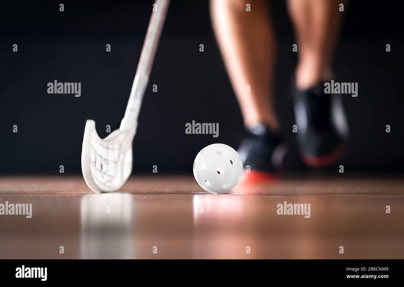 Floorball or floor hockey concept. Player running with ball and stick. Stock Photo