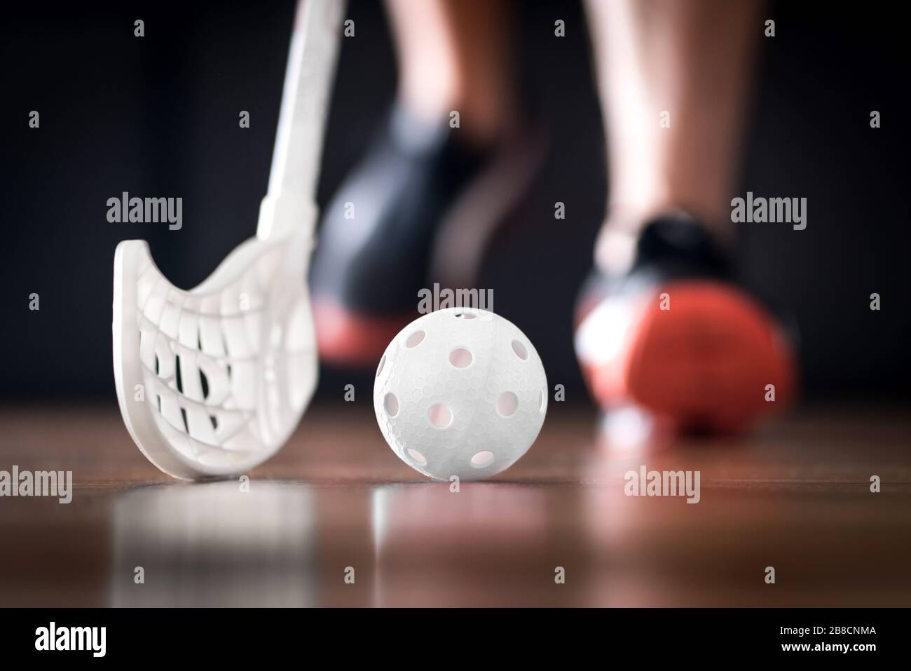 Floorball player running with ball and stick. Floor hockey concept. Stock Photo